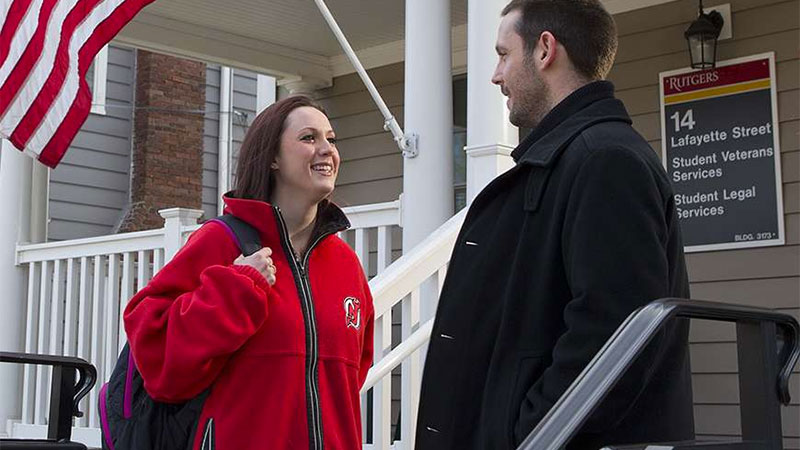 Rob Bright, a former Navy intelligence specialist, now serves as assistant director of Rutgers’ Office of Veterans & Military Programs & Services. Here, at the entrance to Veterans House on the Rutgers campus, Bright talks with Caitlin McCarthy, a four-year Marine Corps veteran who served in Iraq.