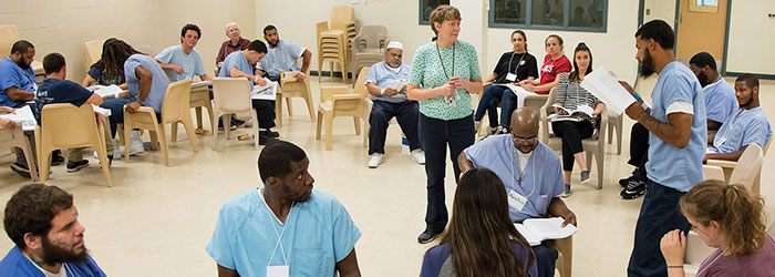 Large-group discussions—like this one among a mixed group of incarcerated and non-imprisoned students at the minimum-security Cambria Community Center—create unique learning opportunities for both populations.