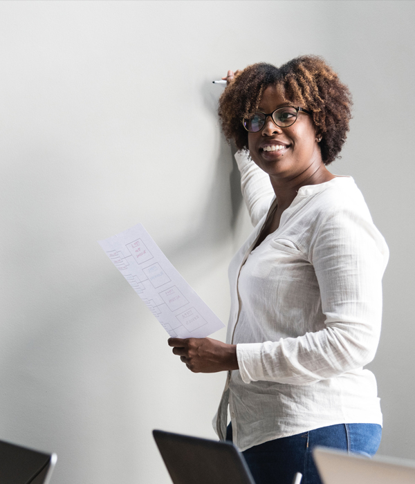 Woman writing on whiteboard