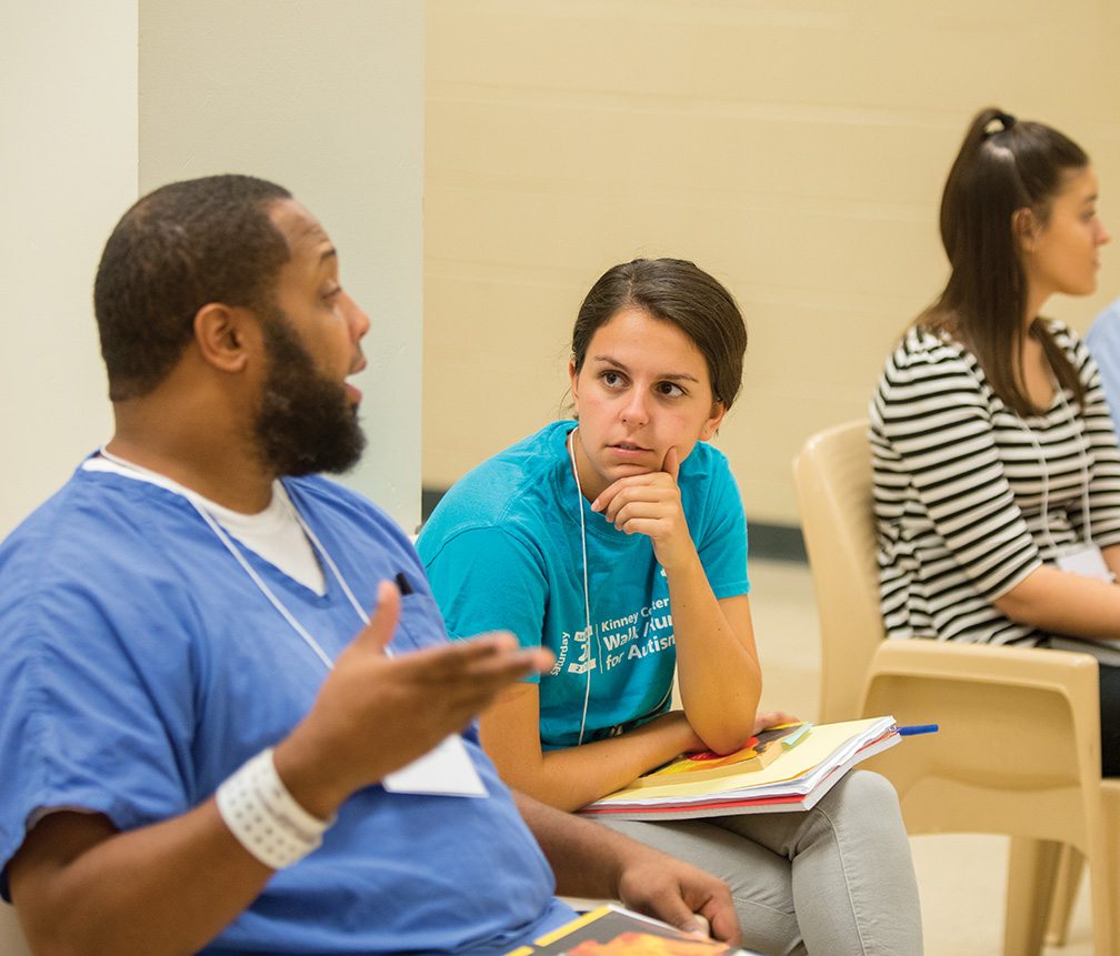 Kasie, a junior at St. Joseph’s University, listens intently to Jermayne, one of her imprisoned peers at the Cambria center. She says her family and friends sometimes “just don’t understand that the people here are just as smart or smarter than I am.”