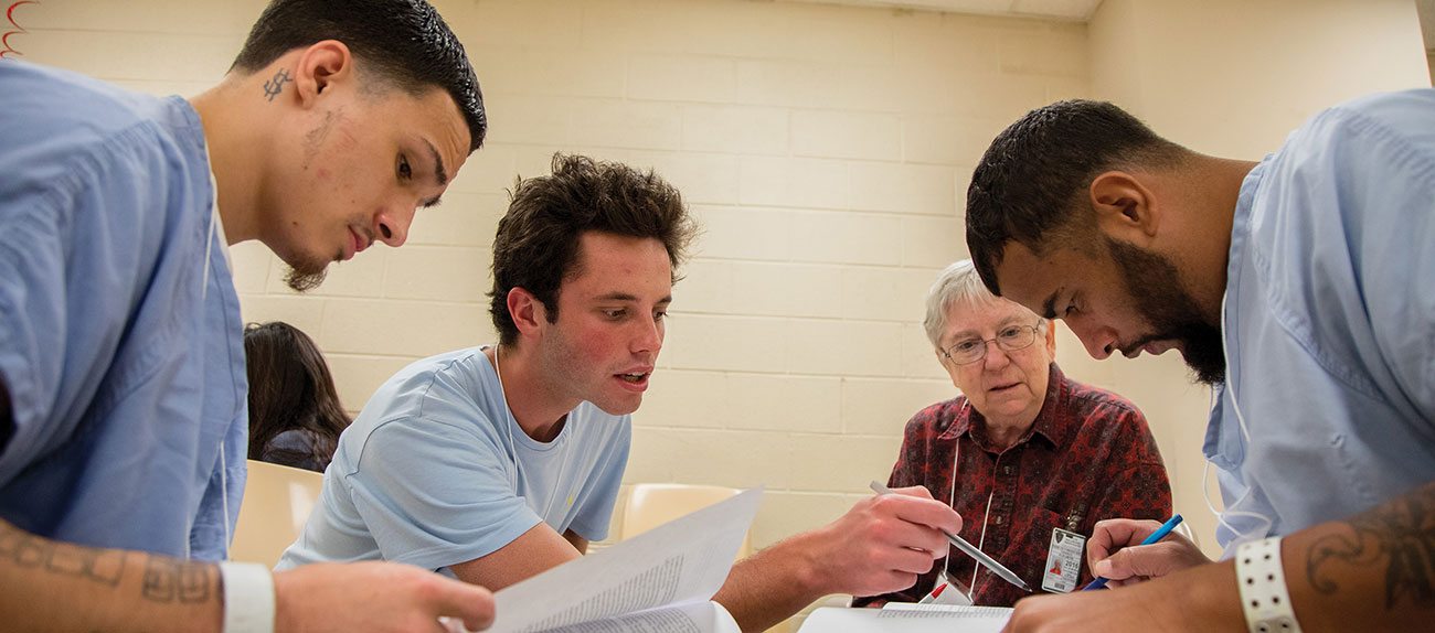 During a small-group breakout session at the Cambria Community Center, inmates Miguel (far left) and Hector (far right) work with Marty, a St. Joseph’s University senior majoring in English and faith studies, and Betsy, a professor at SJU.