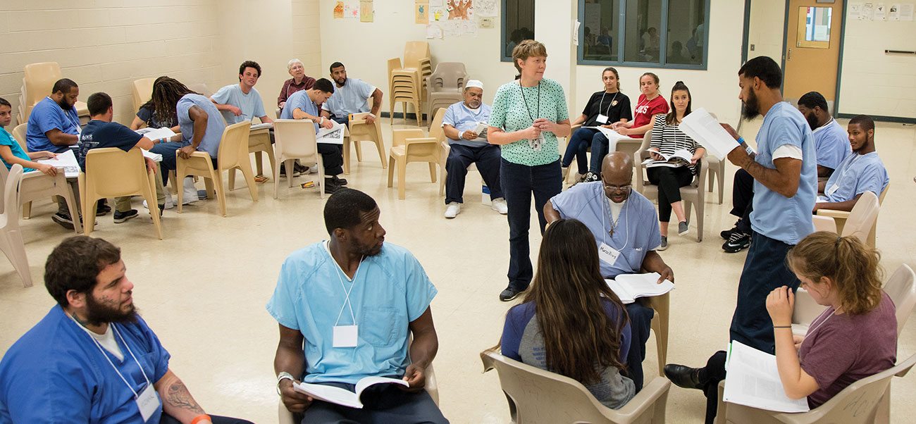 Large-group discussions—like this one among a mixed group of incarcerated and non-imprisoned students at the minimum-security Cambria Community Center—create unique learning opportunities for both populations.