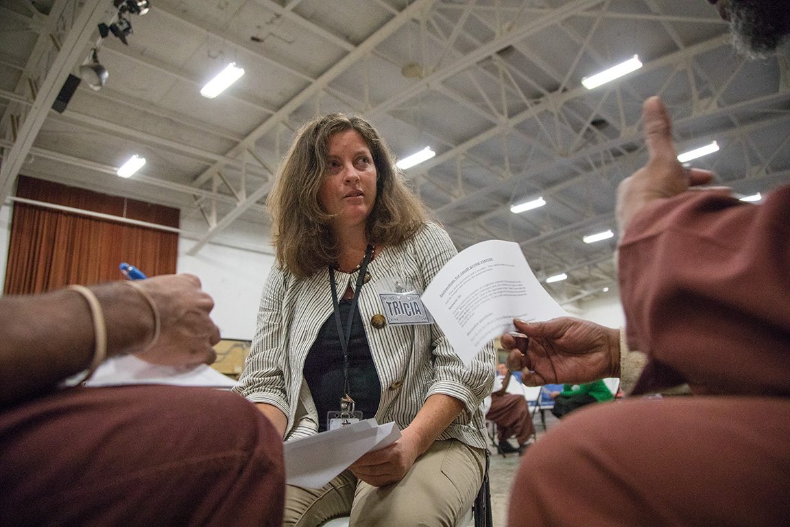 Tricia Way, associate director of Inside-Out, confers with students in her gender and masculinity course at a medium-security facility in Chester, Pa., near Philadelphia.