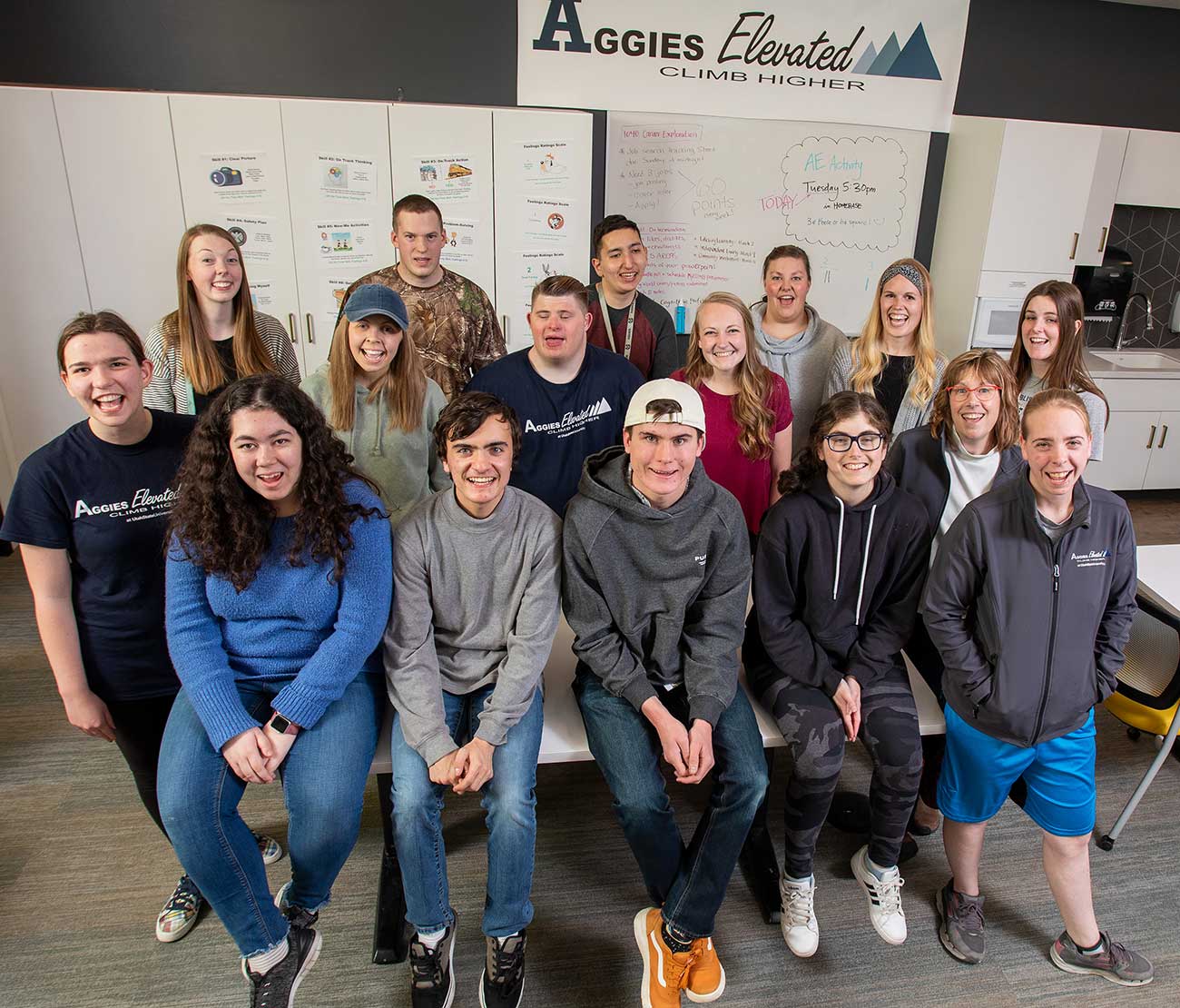 Group picture of 3 rows of smiling Aggies Elevated students.