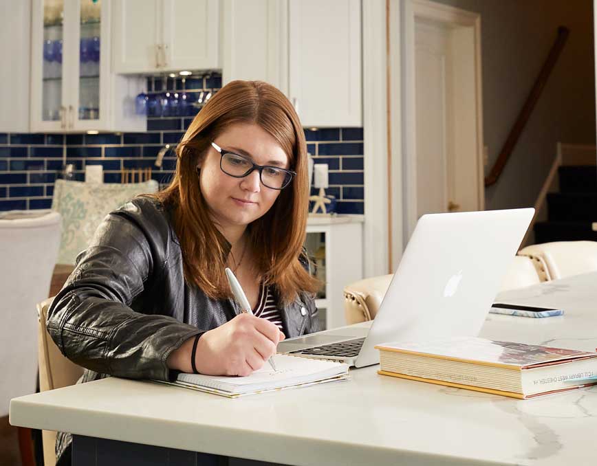 Kelsey Borror studying in her kitchen.