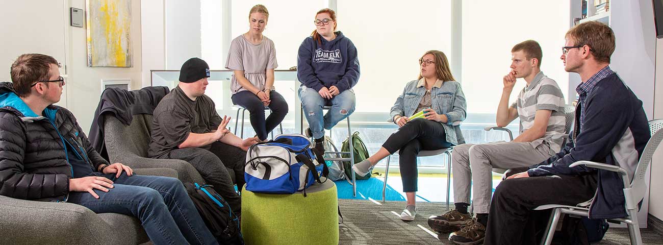 Group shot of students seated in a circle.