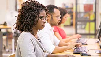 Stock photo: students at row of computers working independently