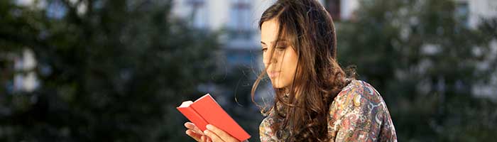 Stock art: Student reading outdoors on campus