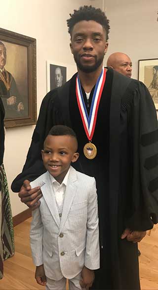 Boseman pictured with the author's son, William Howard Jr.