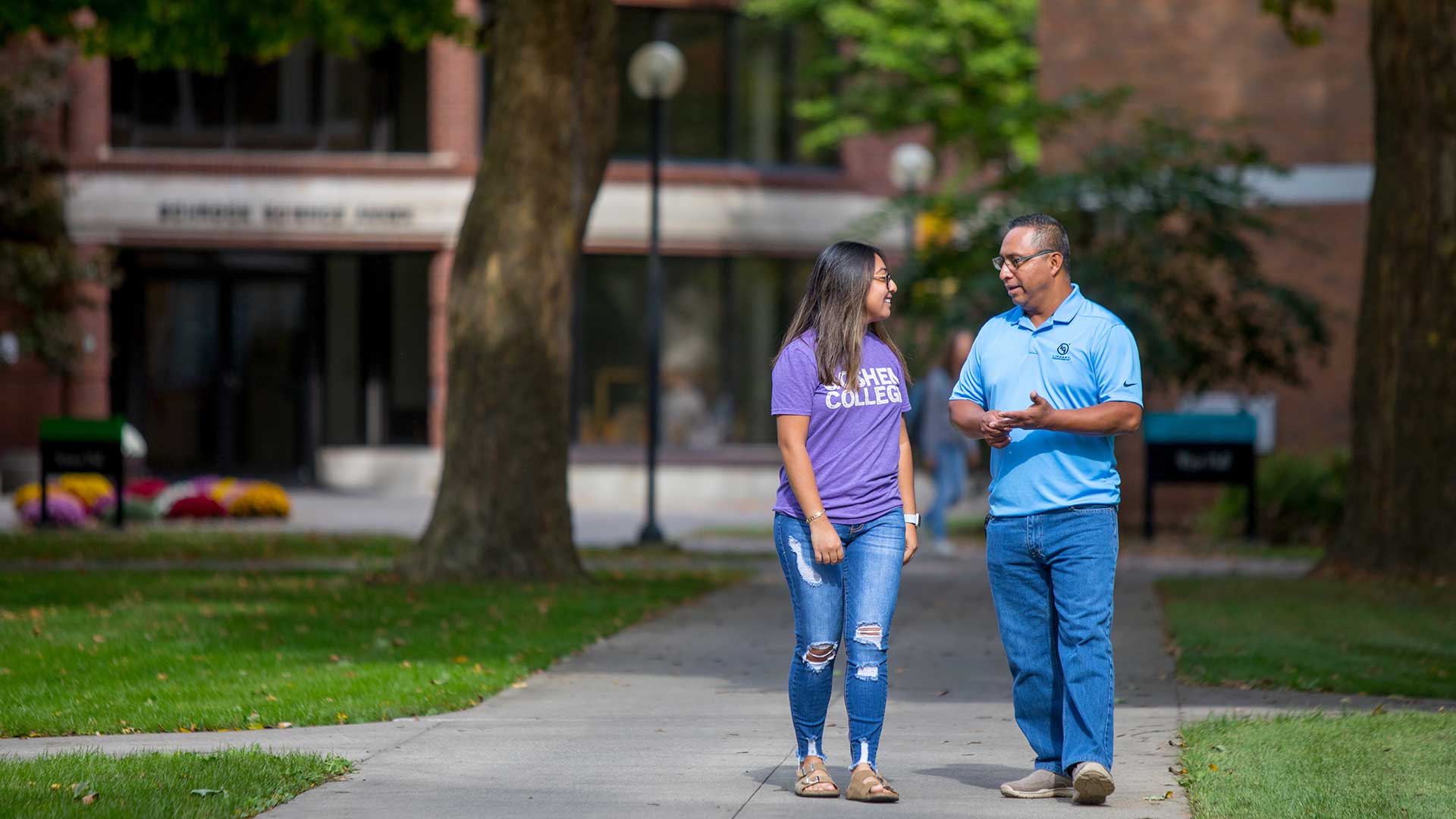 Adult learner Manny Cortez walking on the Goshen College campus with his 19-year-old daughter Kelly.