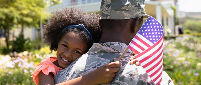 Black soldier holding daughter, stock photo