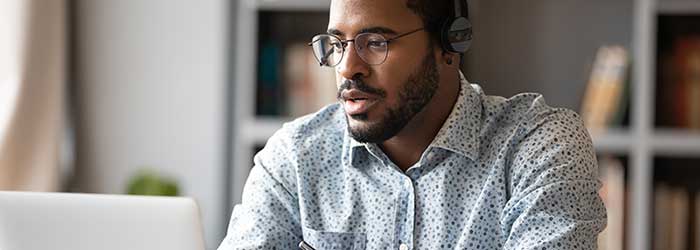 Black adult student engaged in online learning.