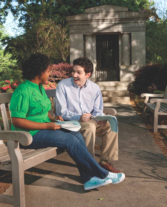 Students Cartiér Gwin and Michael Mohr outdoors laughing.