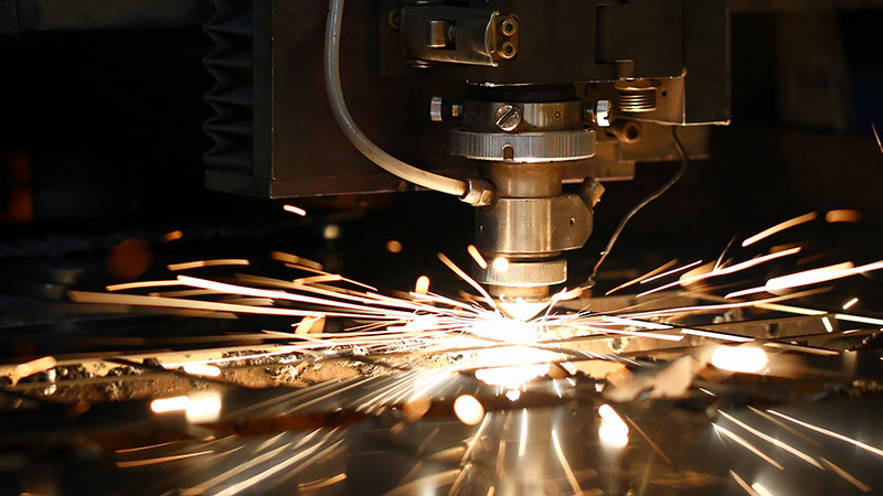 A factory cutting tool squeezing out sparks.