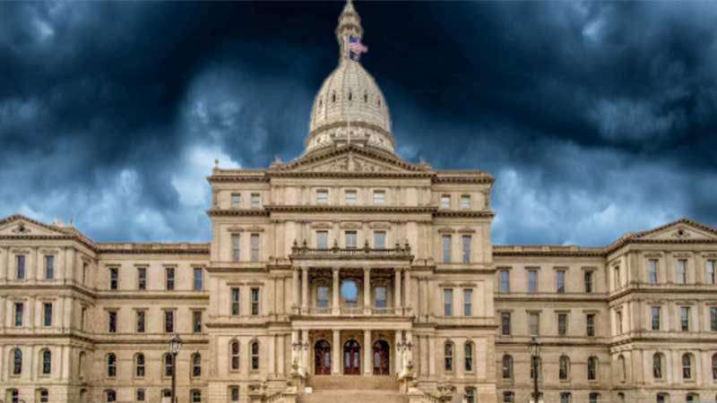 State capitol building with storm clouds in the background.