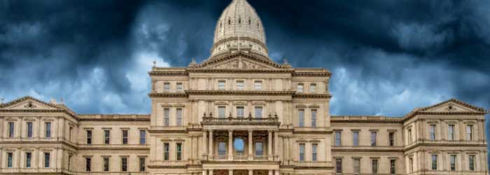 State capitol building with storm clouds in the background.