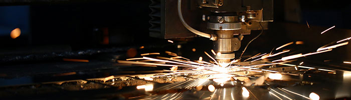 A factory cutting tool squeezing out sparks.