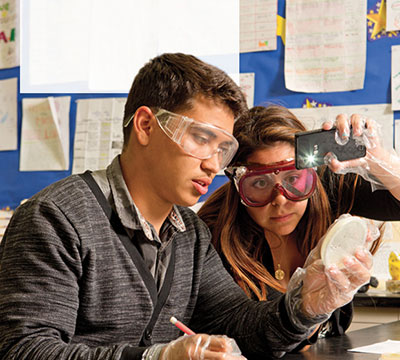 Fabien Cuen and Adriana Herrera work on a science experiment as part of the Anteater Academy program at Valley High School in Santa Ana, Calif.