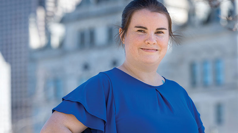 Adult student standing in front of the Connecticut State Capitol where she works full time.