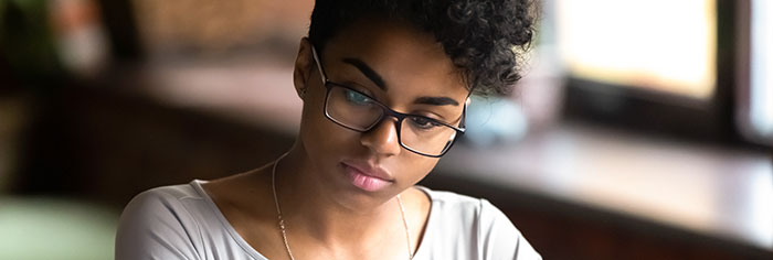 Woman in glasses studying.