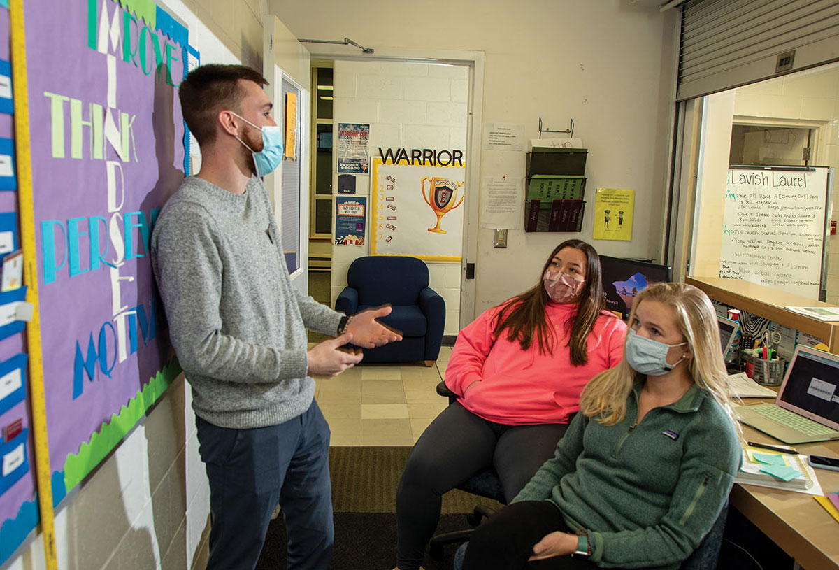 Brett Harrell confers with fellow RAs Megan Perrin and Meagan Hanratty.