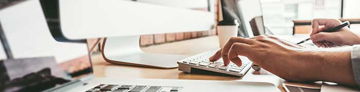 A productivity desktop shows 3 computers, a cup of coffee, and a hand typing. The user appears to be coding.