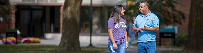 Manny Cortez walking with his 19-year-old daughter Kelly on the campus of Goshen College.