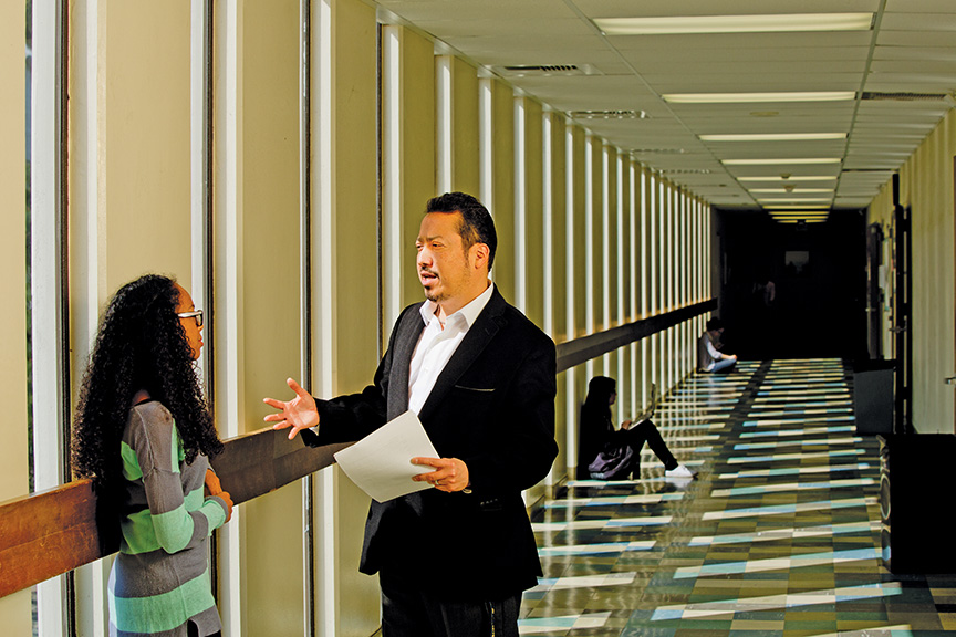 Alexandro Jose Gradilla, assistant professor of Chicana and Chicano Studies at California State University-Fullerton, talks with student Ashley Adams. Gradilla volunteers in the Summer Scholars Program, which eases the transfer of Santa Ana College graduates to four-year institutions.