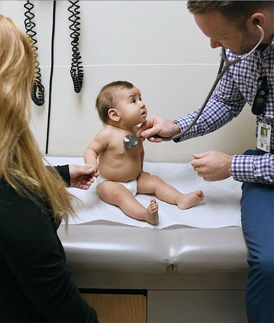 Baby getting stethescoped. Stock cutaway from what is otherwise a talking head video.
