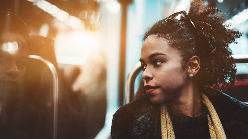 Black, female student on public transit.