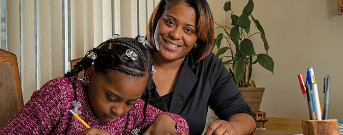 A mother helping daughter with her homework.