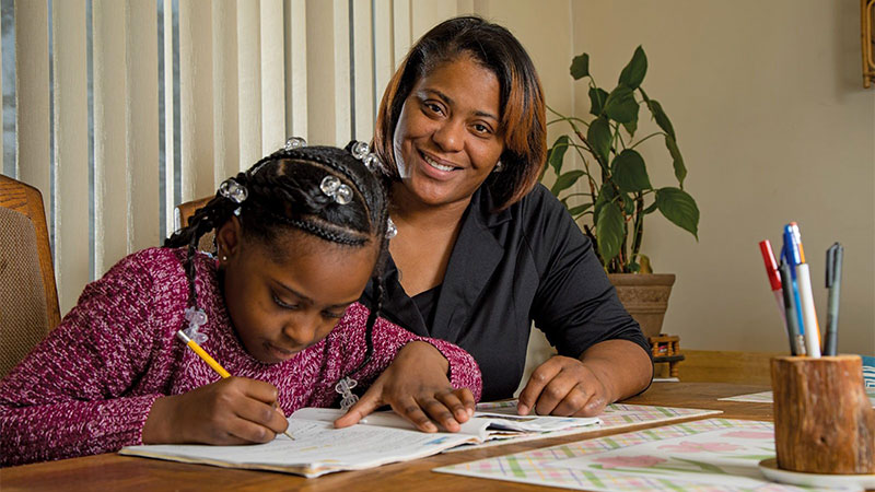 A mother helping daughter with her homework.