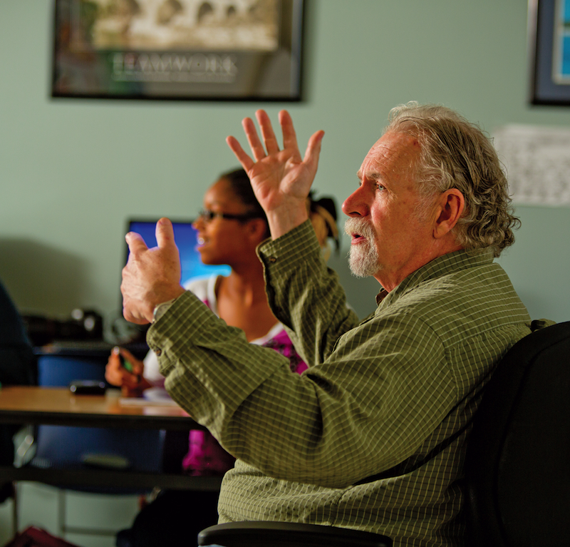 Candid shot of Geoffrey Lapin gesticulating with both hands.