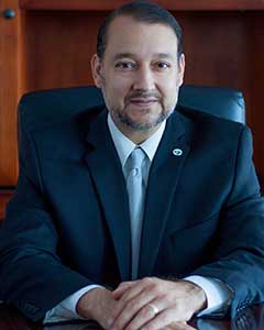 Small headshot of William Serrata at his desk.