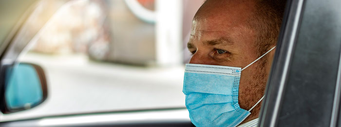Cab driver in a covid mask.