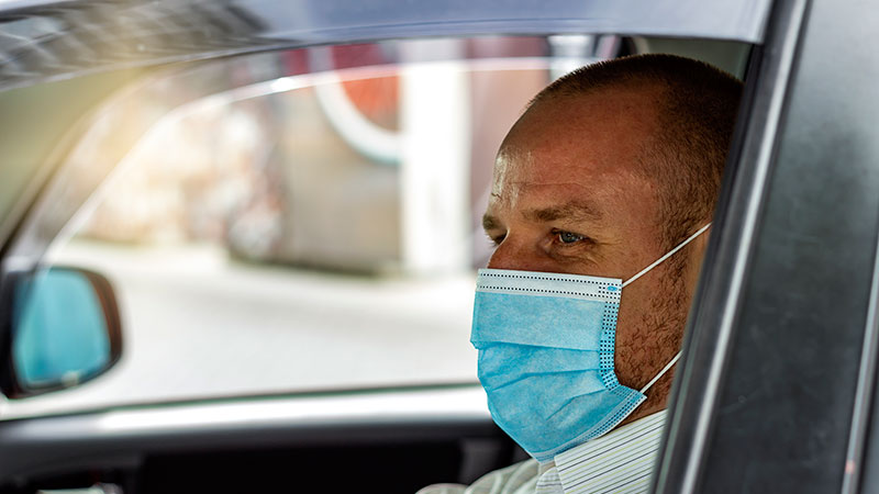 Cab driver in a covid mask.