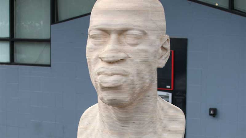 A memorial bust of George Floyd's face with eyes closed.