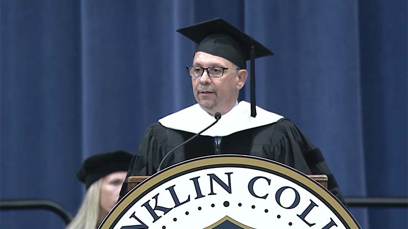 Jamie Merisotis at the lectern, speaking at the 2022 Franklin College Commencement.