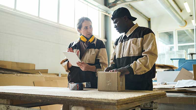 Two people working in a warehouse.