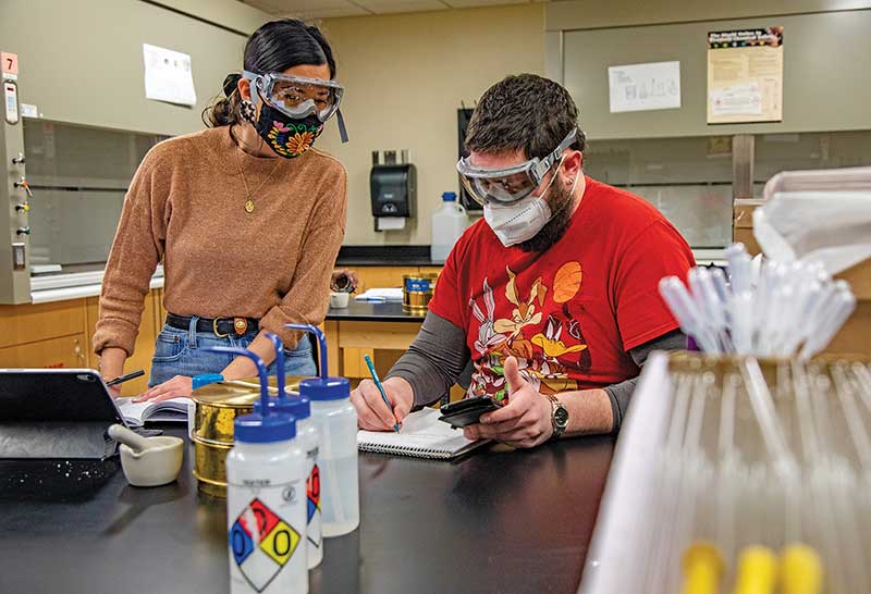 Antavia Paredes-Beaulieu works in a university lab with Kevin Salmela, a fellow student in her environmental chemistry class. Their high-tech task? Quantifying microplastics in local soil samples.