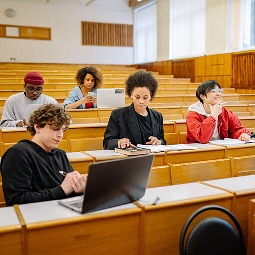 Students looking bored in a lecture hall.