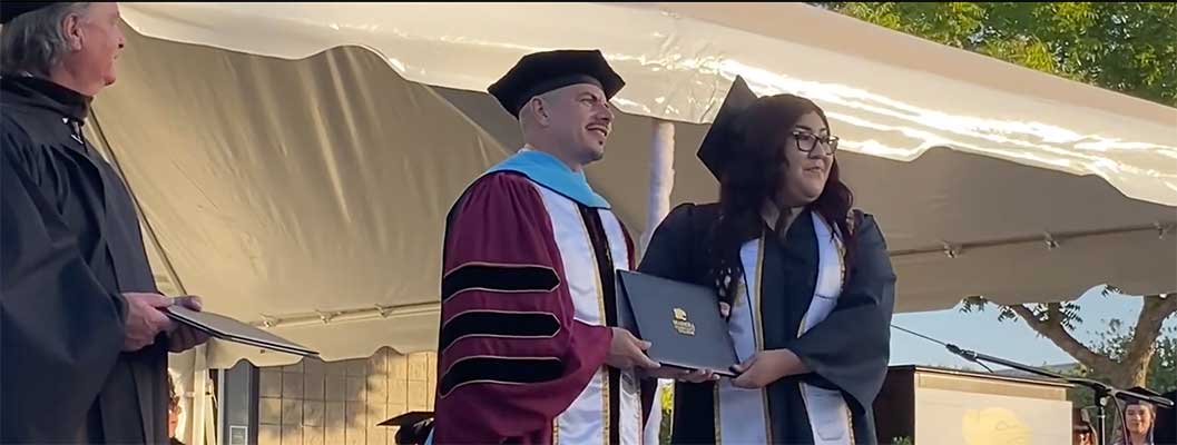 Graduate getting her diploma at ceremony