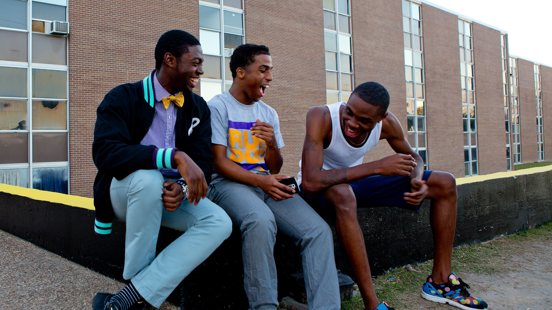 Paul Quinn College (PQC) student Kevin Lee (center) helps pay his way through school by working as a residence hall adviser. Here he shares a laugh with two of his dormitory mates, Vincent Owoseni (left) and Jaytee Paramore.