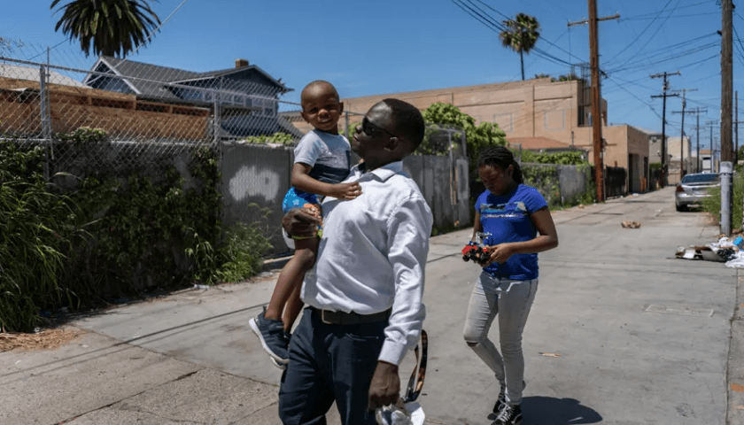 Okello and his children, Emily (10) and Ezekiel (3).