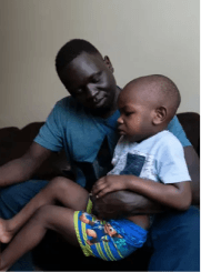 Okello holding his child