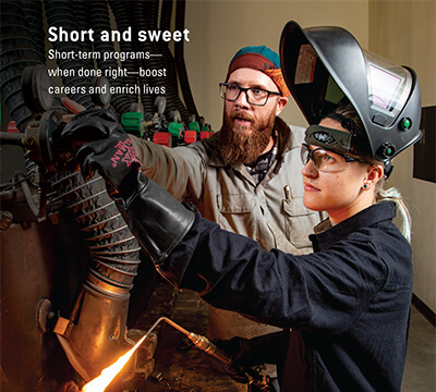 Inset from front cover shows Cat Beaver with instructor doing some welding.