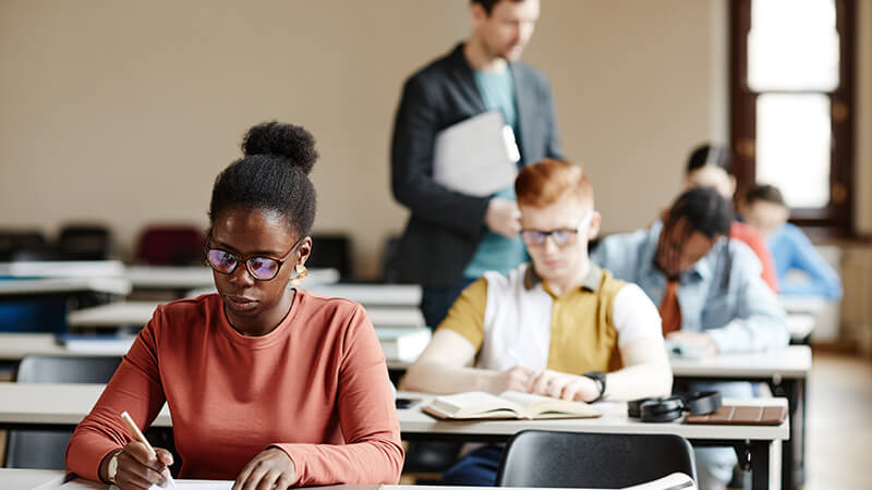 Students Taking Exam in Classroom stock photo