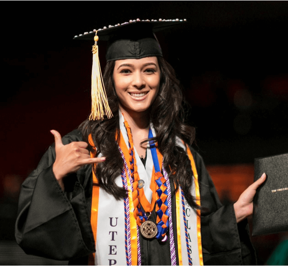 Yet another pic of a new graduate in a mortar board. At least this one is waving the hang 10 sign for some variation.