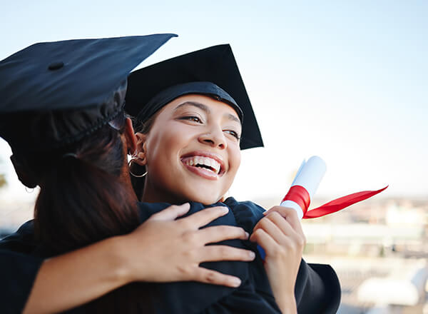 Stock photo of graduation hug.