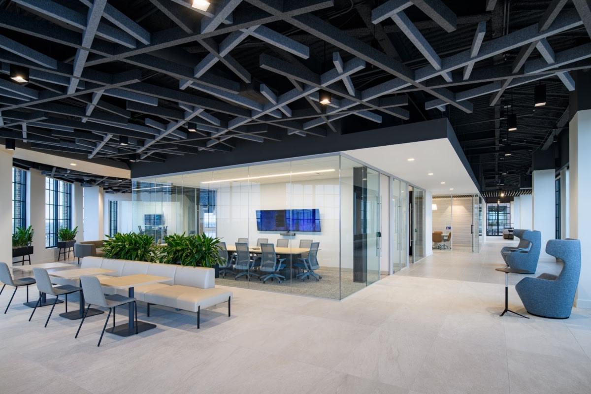 Interior of Lumina Foundation's Indianapolis office at Bottleworks, with an open collaborative seating area and glass-walled conference room